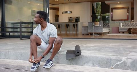 Active Man Preparing for Outdoor Workout on Modern Patio
