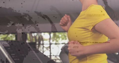 Running woman wearing yellow shirt on treadmill with world map and code overlay