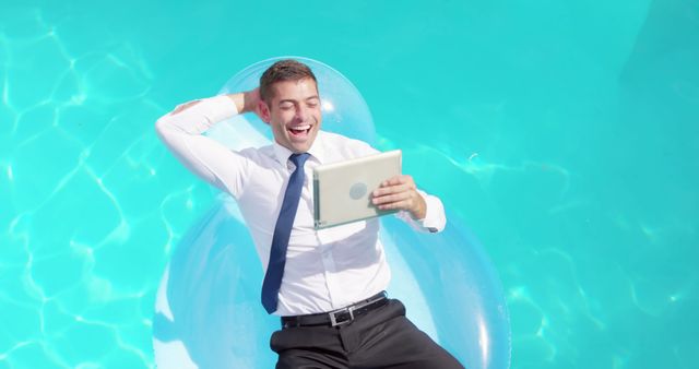 Businessman Relaxing in Pool with Tablet on Inflatable Lounger - Download Free Stock Images Pikwizard.com