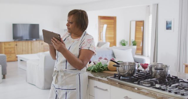 Senior Woman Cooking and Using Tablet in Modern Kitchen - Download Free Stock Images Pikwizard.com