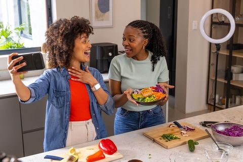 African American Friends Filming Cooking Demo Preparing Colorful Salad on Kitchen Island
