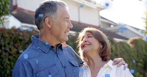 Smiling couple embracing in sunny suburban yard, enjoying peaceful neighborhood life