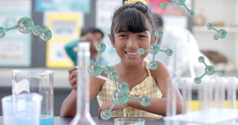Curious girl exploring molecular structures in science classroom