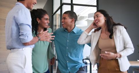 Multiracial team celebrating success in modern office