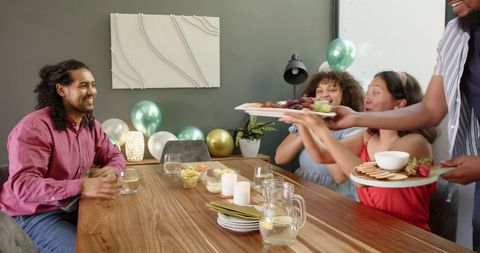 Friends Enjoying House-warming Party with Food and Drinks