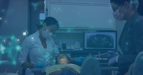 Caucasian Dentist with Nurse Assists Young Patient Using Advanced Dental Technology