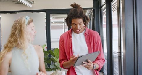 Engaged Colleagues Discussing Project with Tablet in Office