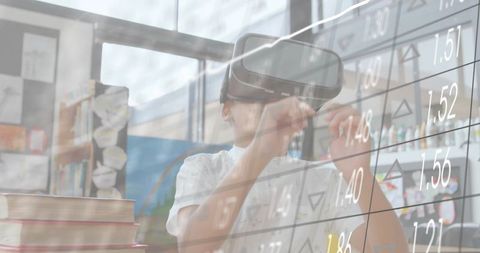 Schoolboy exploring virtual stock market with vr headset in classroom for edtech