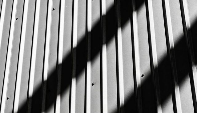Corrugated Metal Wall with Diagonal Shadow Bands Monochrome Industrial Geometry