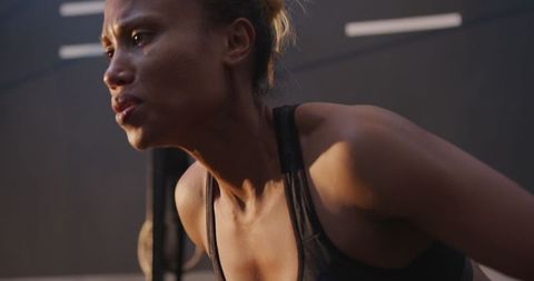 Determined athlete lifting weights at gym