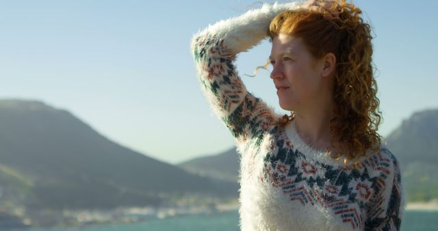 Woman with Red Curly Hair Enjoying Mountain View in Warm Sweater - Download Free Stock Images Pikwizard.com