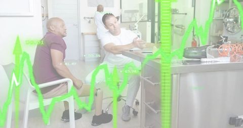 Technician explaining tablet in prosthetic consultation with patient wearing leg prosthesis