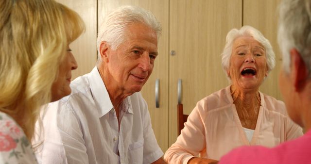 Senior Friends Laughing and Enjoying Time Together Indoors - Download Free Stock Images Pikwizard.com