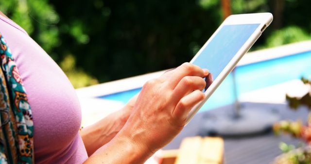 Person Using a Tablet by the Poolside - Download Free Stock Images Pikwizard.com