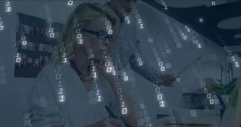 Businesswoman Taking Notes at Laptop with Binary Code Overlay for Data Collaboration