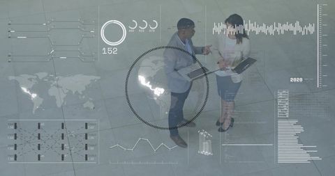 Colleagues analyzing global analytics on laptops with AR overlay in corporate atrium