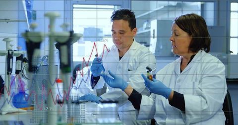 Mentor-Mentee Scientists Analyzing Data in Research Laboratory