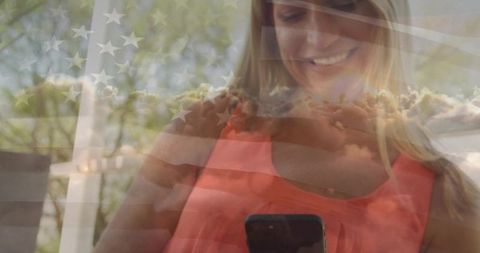 Smiling Woman Using Smartphone Outdoors with Flag Overlay