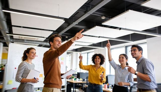 Leading collaborative brainstorming with pointing leader in open-plan office