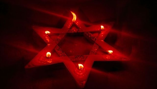 Mystical six-pointed star candle holder with warm red glow