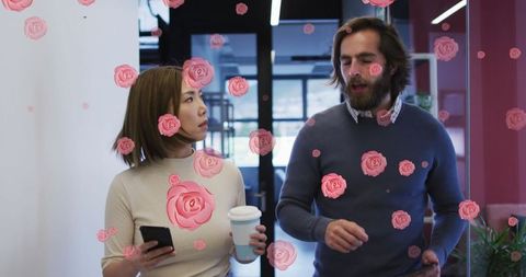 Walking colleagues surrounded by digital roses in modern office corridor