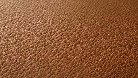 Warm brown pebbled leather texture close-up luxury upholstery grain surface