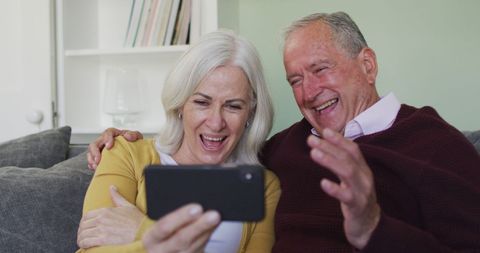Happy Senior Couple Taking Selfie on Sofa