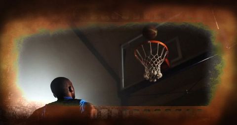 Athletic Focus as Basketball Swishes Through Hoop Indoor Gym