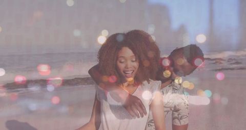 Joyful Couple Enjoying Seaside with Bokeh Accents