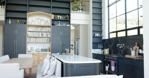 Modern Open-Plan Kitchen with Matte Dark Cabinets, White Quartz Island, Built-In Bookshelf