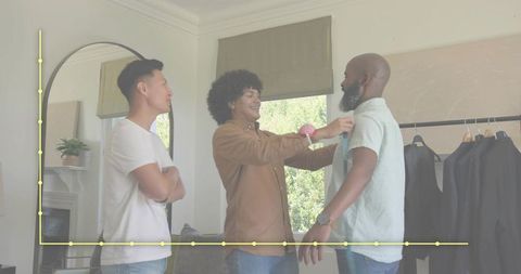 Tailoring consultation measuring bearded client with tape measure in boutique fitting room