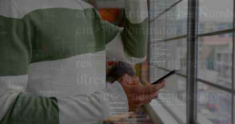 Modern developer analyzing code on smartphone in office