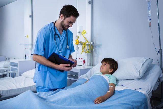 Male Nurse Interacting with Young Patient in Hospital Ward - Download Free Stock Photos Pikwizard.com