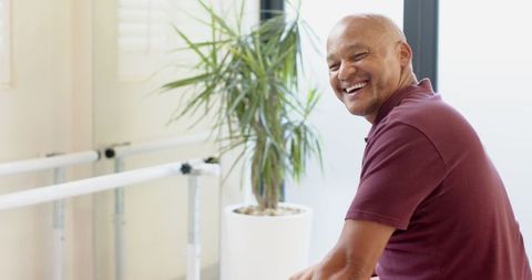 Smiling Mature Man in Physiotherapy Room Relaxing