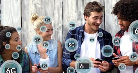 Diverse Friends Engaging with Advanced Mobile Technology Outdoors