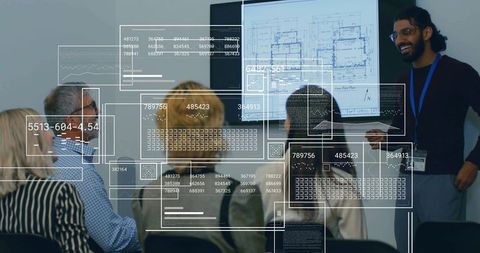 Man Presenting Floor Plan with Data Overlay in Office Conference