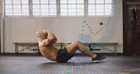 Shirtless athlete performing crunches on gym floor with biometric data overlay