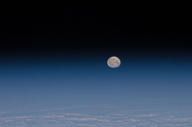 ISS030-E-028977(9 Jan. 2012) ---    One of a series of photos of the moon and Earth’s atmosphere as seen from the International Space Station over a period of time that covered a number of orbits by the orbital outpost.                