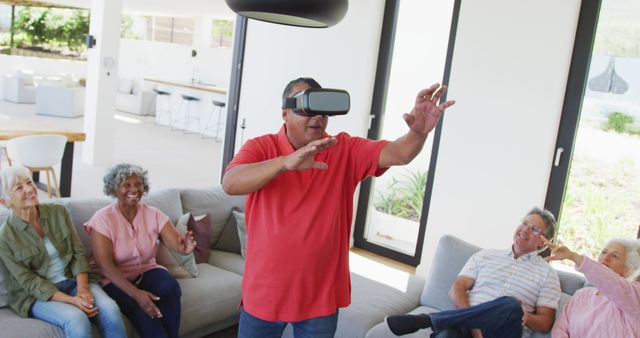 Senior Man Using VR Headset in Living Room with Friends Watching - Download Free Stock Images Pikwizard.com