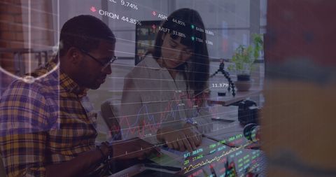 Diverse colleagues analyzing financial data in modern office