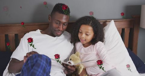 Father and Daughter Reading in Bed Surrounded by Roses - Download Free Stock Images Pikwizard.com