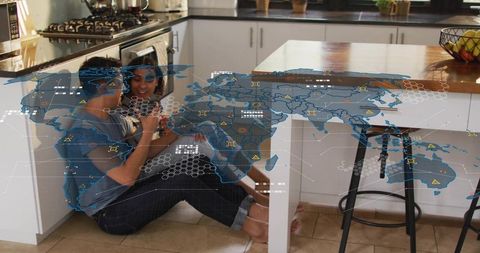 Couple cuddling on sunlit kitchen floor with holographic world map overlay, tech romance