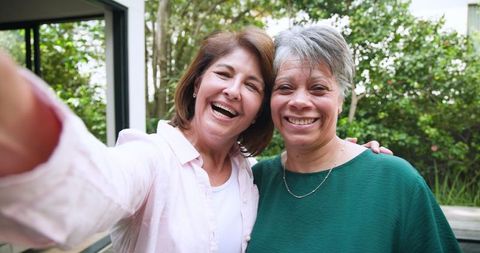 Smiling Diverse Female Friends Taking Selfie on Garden Patio