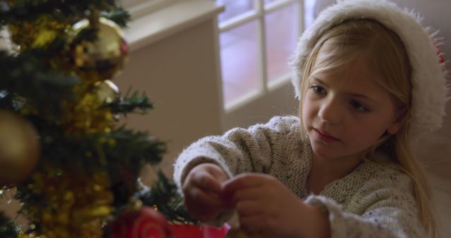 Little Girl Decorating Christmas Tree Wearing Santa Hat - Download Free Stock Images Pikwizard.com