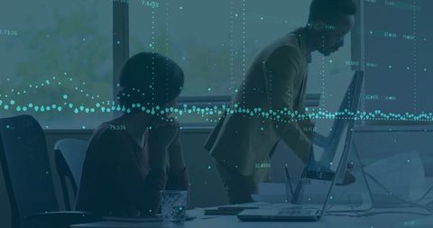 Collaborating Team Analyzing Data on Office Computers