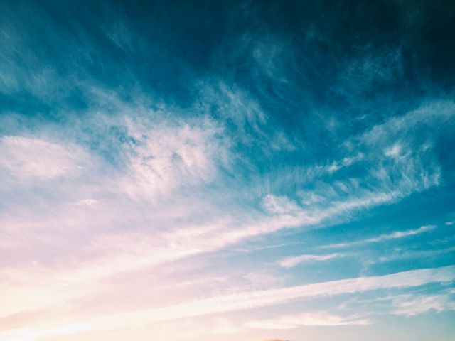 Sky with shades of blue and pink as the sun rises. Ideal for backgrounds, wallpapers, motivational posters, website headers, and nature-related content. Perfect for highlighting themes of beginnings, peace, and natural beauty.