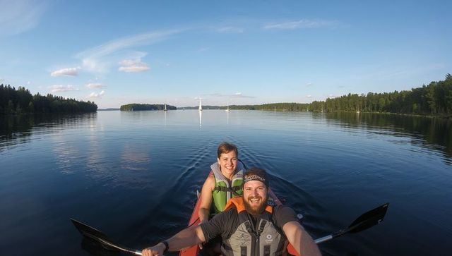 Couple Paddling Tandem Kayak on Tranquil Lake at Sunrise