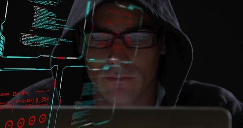 Hooded coder studying laptop code with futuristic hud overlay and neon interface glow
