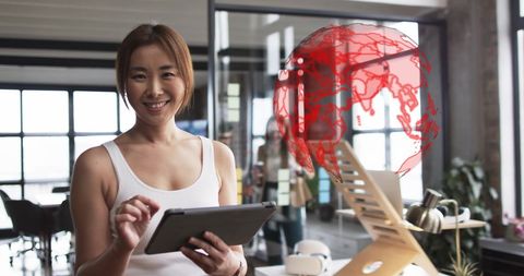 Businesswoman Analyzing Data on Digital Tablet with Globe Projection
