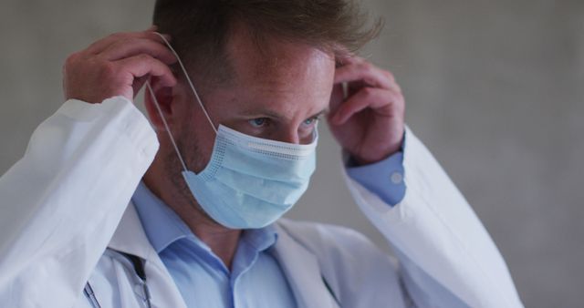 Doctor Adjusting Face Mask in Healthcare Setting - Download Free Stock Images Pikwizard.com